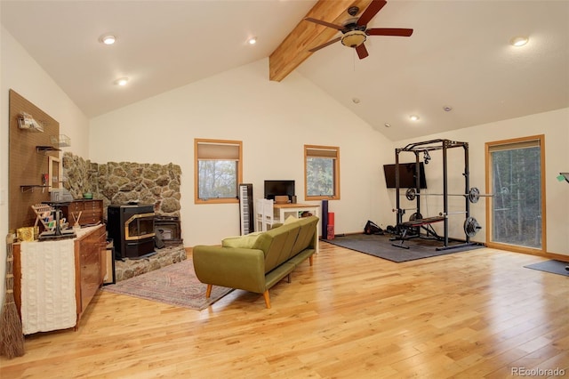 2720 S Spring Gulch Rd, Idaho Springs, CO 80452 - living area featuring a wood stove, light wood-style floors, a ceiling fan, beamed ceiling, and high vaulted ceiling
