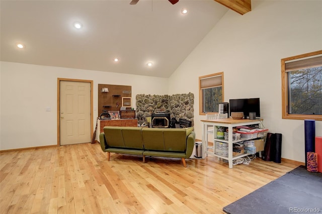 2720 S Spring Gulch Rd, Idaho Springs, CO 80452 - living area with a wood stove, ceiling fan, light wood finished floors, beamed ceiling, and high vaulted ceiling