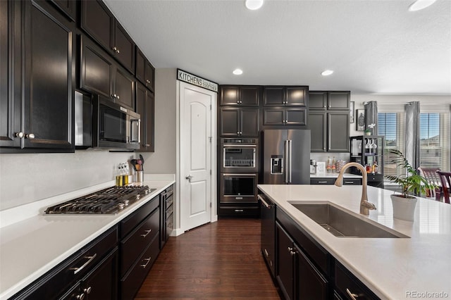 398 Midden Pl, Castle Rock, CO 80104 - kitchen featuring appliances with stainless steel finishes, dark wood finished floors, light countertops, recessed lighting, and dark cabinetry
