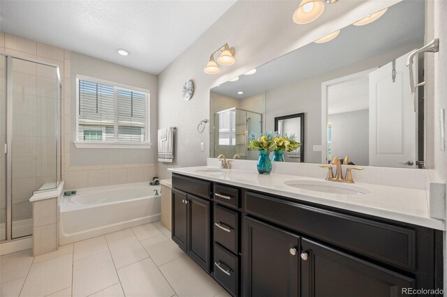398 Midden Pl, Castle Rock, CO 80104 - bathroom with tile patterned floors, a stall shower, double vanity, a garden tub, and recessed lighting