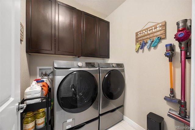 398 Midden Pl, Castle Rock, CO 80104 - laundry room with cabinet space, washing machine and dryer, and light tile patterned flooring