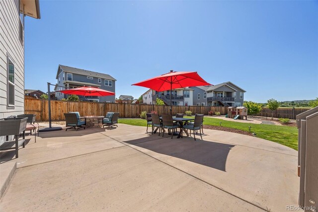398 Midden Pl, Castle Rock, CO 80104 - fenced backyard featuring a playground, a patio area, a fire pit, and outdoor dining space