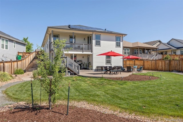 398 Midden Pl, Castle Rock, CO 80104 - rear view of property with roof mounted solar panels, a fenced backyard, a patio, and stairway
