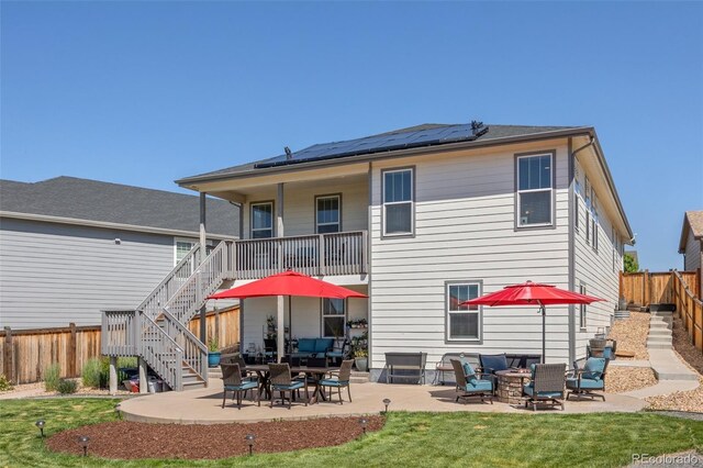 398 Midden Pl, Castle Rock, CO 80104 - rear view of property featuring stairs, solar panels, a fenced backyard, a patio area, and an outdoor hangout area