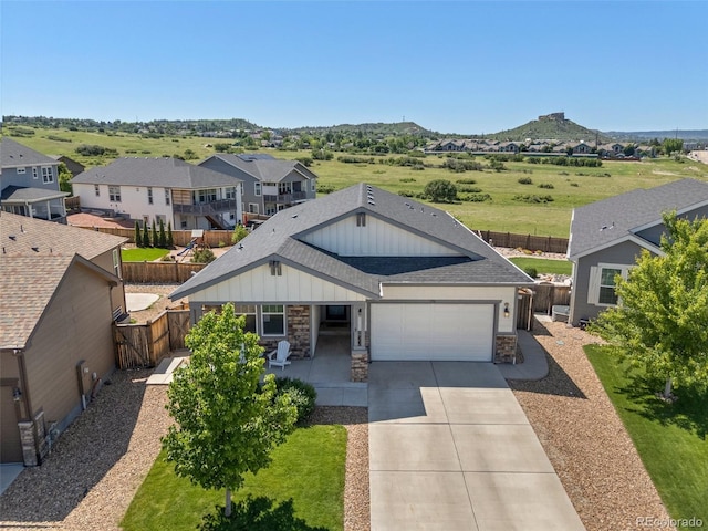398 Midden Pl, Castle Rock, CO 80104 - view of front of home featuring board and batten siding, an attached garage, concrete driveway, stone siding, and a shingled roof