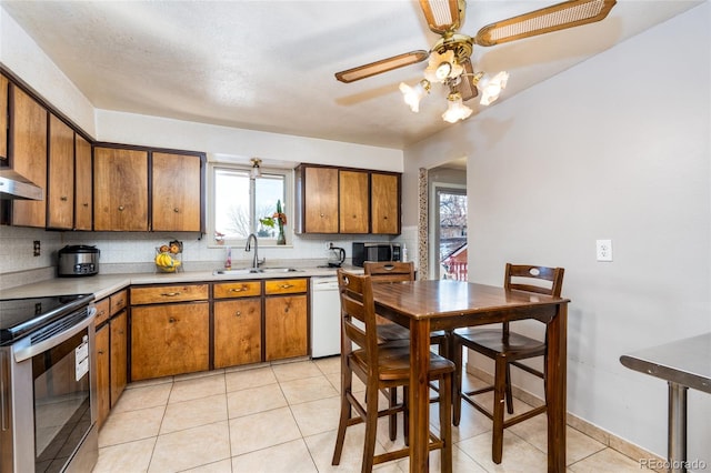 kitchen featuring a wealth of natural light, sink, decorative backsplash, electric range, and white dishwasher