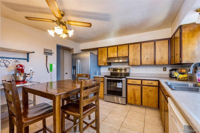 kitchen with light tile patterned flooring, appliances with stainless steel finishes, sink, backsplash, and ceiling fan