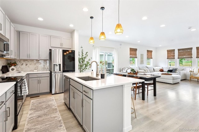 8057 Monte Vista Cir, Littleton, CO 80125 - kitchen featuring gray cabinetry, stainless steel appliances, a sink, recessed lighting, and light wood-style flooring