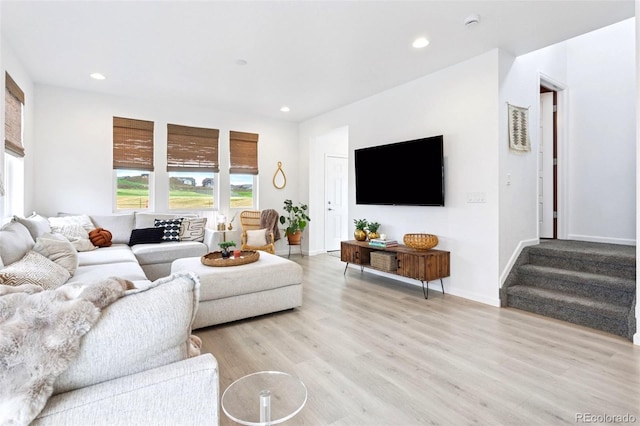 8057 Monte Vista Cir, Littleton, CO 80125 - living area with plenty of natural light, light wood finished floors, recessed lighting, stairway, and baseboards