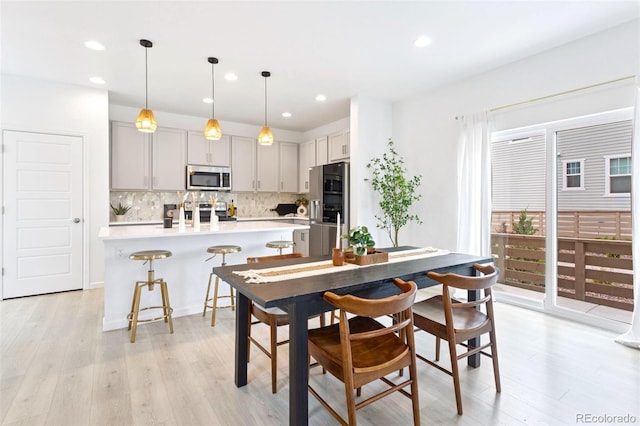 8057 Monte Vista Cir, Littleton, CO 80125 - dining space with light wood-style flooring and recessed lighting