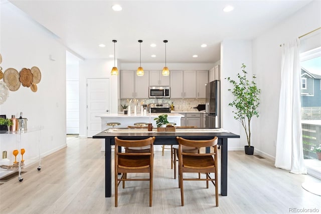 8057 Monte Vista Cir, Littleton, CO 80125 - dining space featuring light wood-style floors, recessed lighting, and baseboards