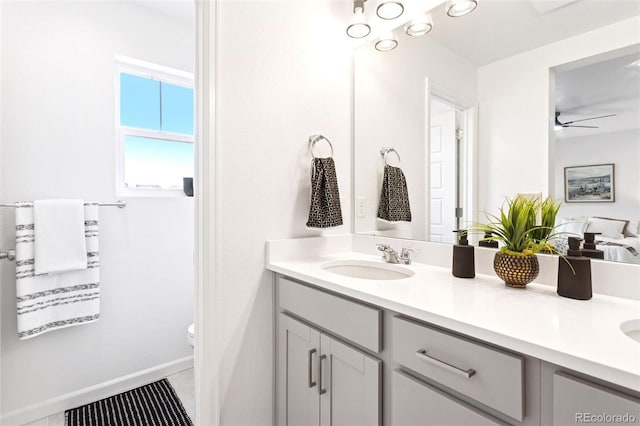 8057 Monte Vista Cir, Littleton, CO 80125 - full bathroom with double vanity, toilet, and ceiling fan