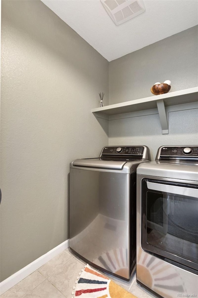 8057 Monte Vista Cir, Littleton, CO 80125 - washroom with separate washer and dryer, light tile patterned floors, and baseboards