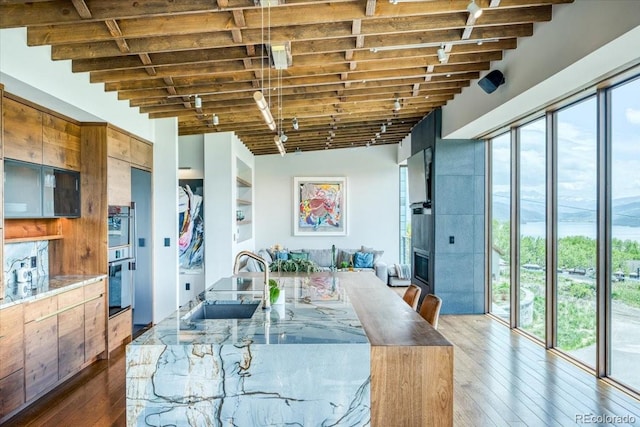 421 Z Rd, Silverthorne, CO 80498 - dining space featuring hardwood / wood-style floors, beamed ceiling, and a fireplace