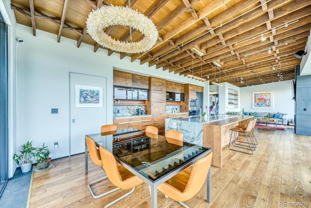 421 Z Rd, Silverthorne, CO 80498 - dining space with light wood-type flooring and a wood ceiling with exposed beams