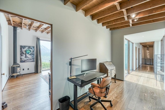 421 Z Rd, Silverthorne, CO 80498 - home office with a wood stove, light wood finished floors, and a wooden ceiling with exposed beams