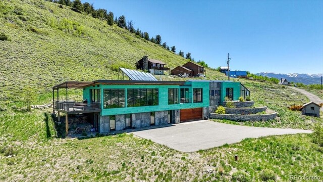 421 Z Rd, Silverthorne, CO 80498 - rear view of house with a mountain view, an attached garage, and stone siding