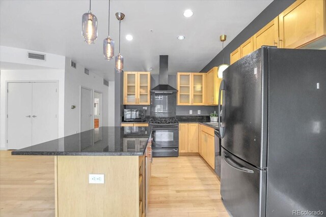 1438 Little Raven St Unit 201, Denver, CO 80202 - kitchen with black appliances, exhaust hood, light brown cabinets, light wood finished floors, and a kitchen island