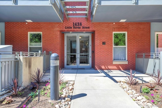 1438 Little Raven St Unit 201, Denver, CO 80202 - view of exterior entry featuring brick siding and french doors