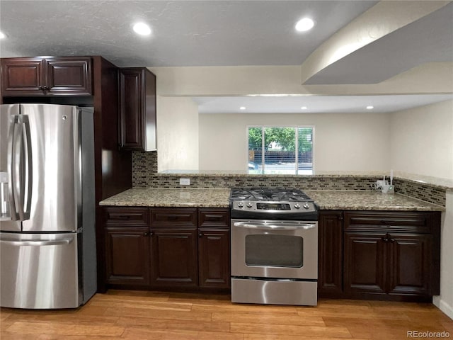 5480 W 74th Ave, Arvada, CO 80003 - kitchen featuring stainless steel appliances, light wood-style floors, backsplash, and recessed lighting