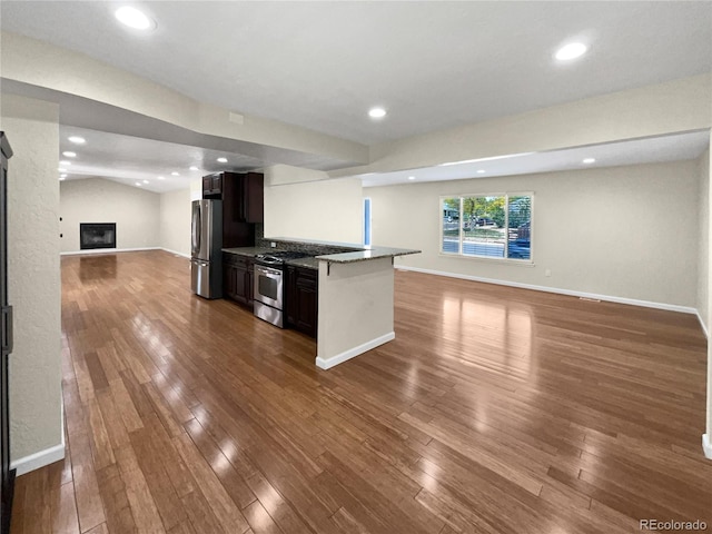 5480 W 74th Ave, Arvada, CO 80003 - kitchen featuring open floor plan, appliances with stainless steel finishes, dark wood-type flooring, and recessed lighting