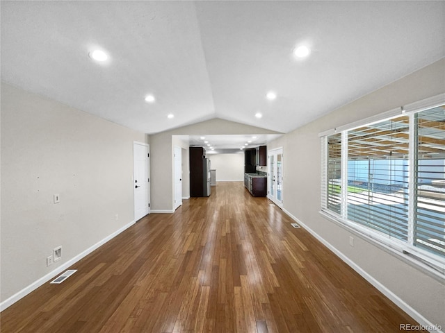 5480 W 74th Ave, Arvada, CO 80003 - unfurnished living room featuring dark wood-style floors, vaulted ceiling, baseboards, and recessed lighting
