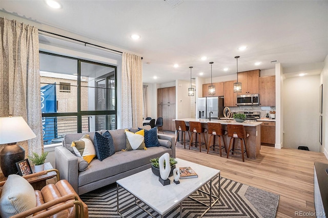 living room featuring a wealth of natural light and light hardwood / wood-style flooring