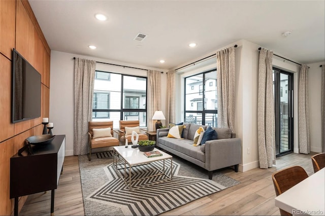 living room with plenty of natural light and light hardwood / wood-style floors