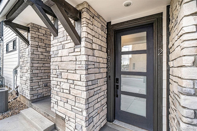 doorway to property featuring central air condition unit