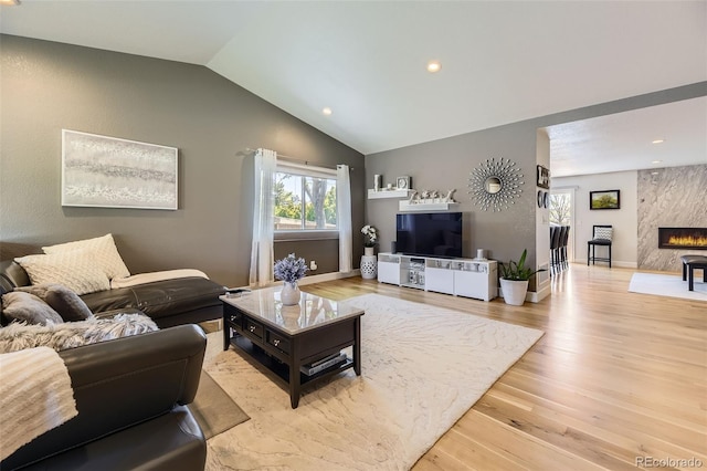 904 Fieldstone Pl, Highlands Ranch, CO 80126 - living area featuring lofted ceiling, a high end fireplace, wood finished floors, recessed lighting, and baseboards
