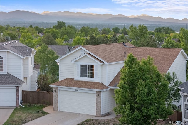 3087 Deer Creek Trl, Highlands Ranch, CO 80129 - view of front of property featuring a mountain view, driveway, brick siding, and an attached garage