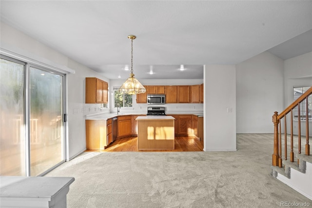 3087 Deer Creek Trl, Highlands Ranch, CO 80129 - kitchen featuring stainless steel appliances, light carpet, a kitchen island, light countertops, and brown cabinets
