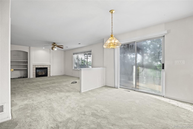 3087 Deer Creek Trl, Highlands Ranch, CO 80129 - unfurnished living room featuring carpet, a ceiling fan, and a fireplace