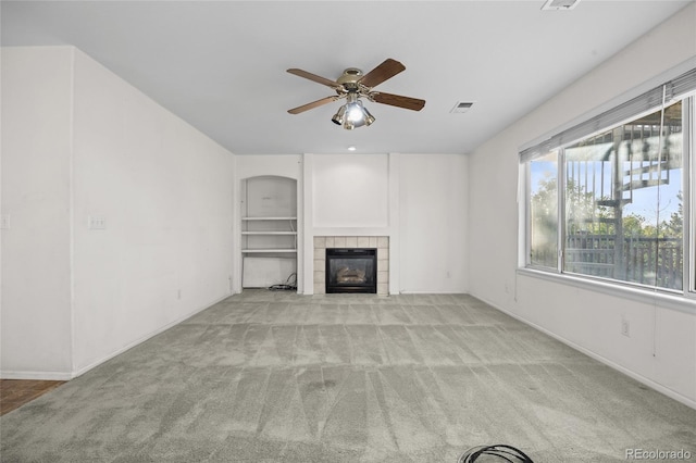 3087 Deer Creek Trl, Highlands Ranch, CO 80129 - unfurnished living room featuring carpet, ceiling fan, a tiled fireplace, and baseboards