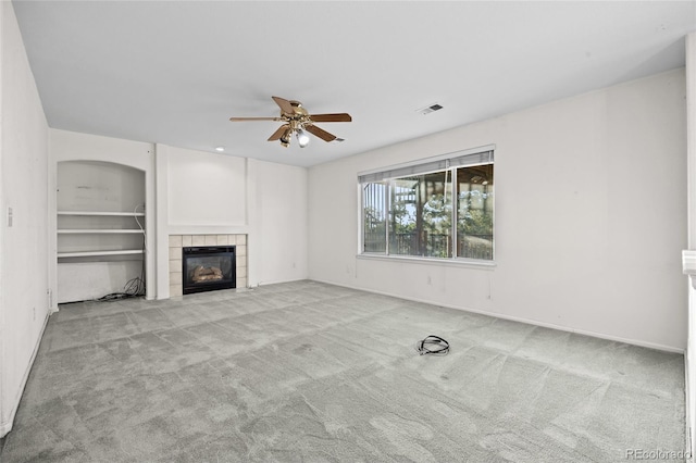 3087 Deer Creek Trl, Highlands Ranch, CO 80129 - unfurnished living room with carpet flooring, ceiling fan, a tiled fireplace, and baseboards