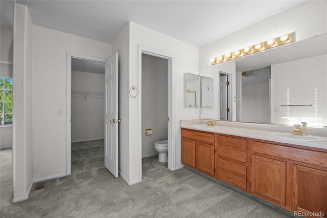 3087 Deer Creek Trl, Highlands Ranch, CO 80129 - bathroom featuring double vanity, toilet, a ceiling fan, and carpet flooring