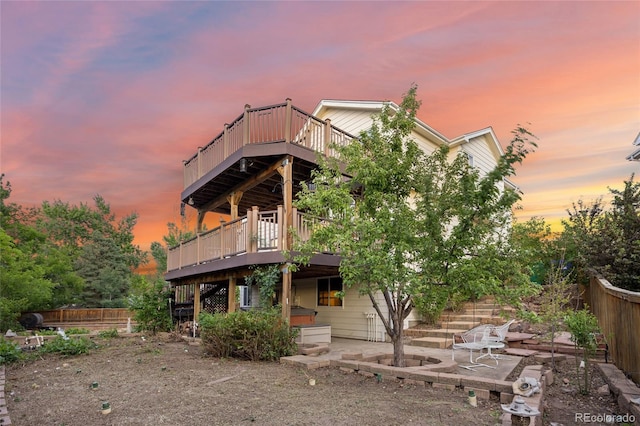 3087 Deer Creek Trl, Highlands Ranch, CO 80129 - back of house at dusk with a wooden deck and a patio