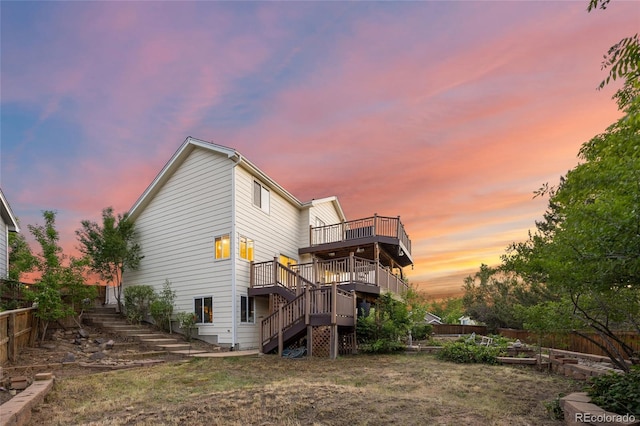 3087 Deer Creek Trl, Highlands Ranch, CO 80129 - back of house with stairs, a wooden deck, and a vegetable garden