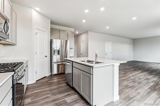 14440 Ranch St, Mead, CO 80504 - kitchen featuring gray cabinetry, stainless steel appliances, dark wood finished floors, a center island with sink, and recessed lighting