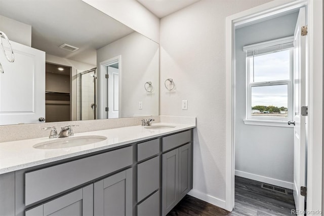 14440 Ranch St, Mead, CO 80504 - bathroom with double vanity, wood finished floors, and an enclosed shower