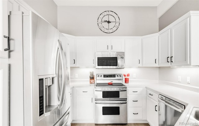 kitchen featuring white cabinetry and appliances with stainless steel finishes