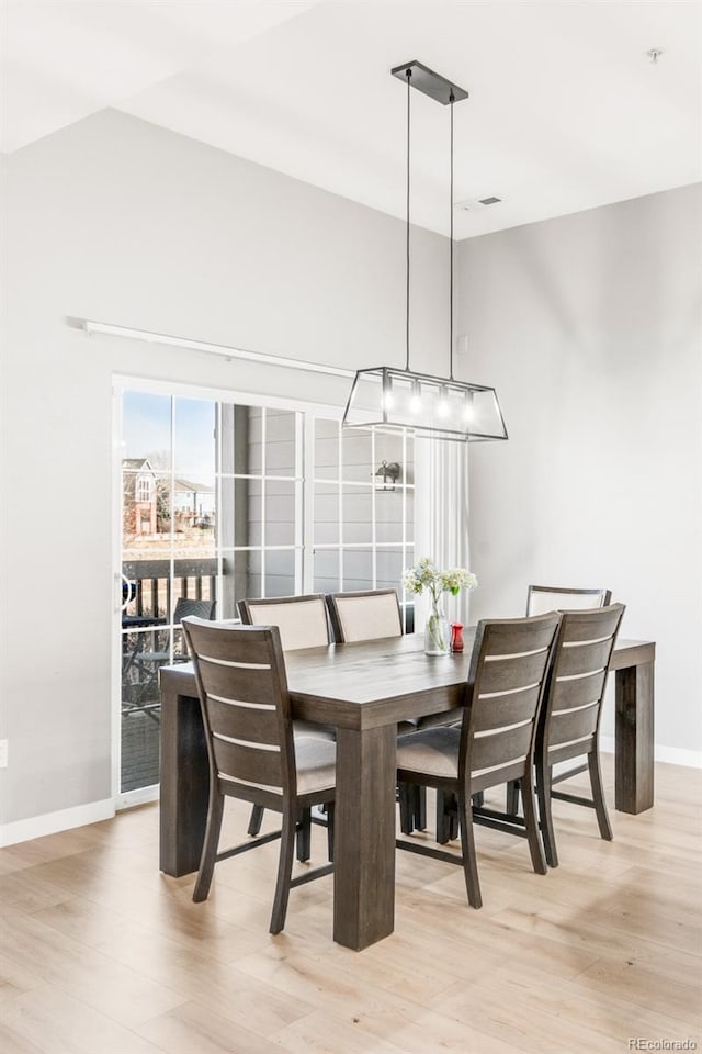 dining space with light hardwood / wood-style flooring