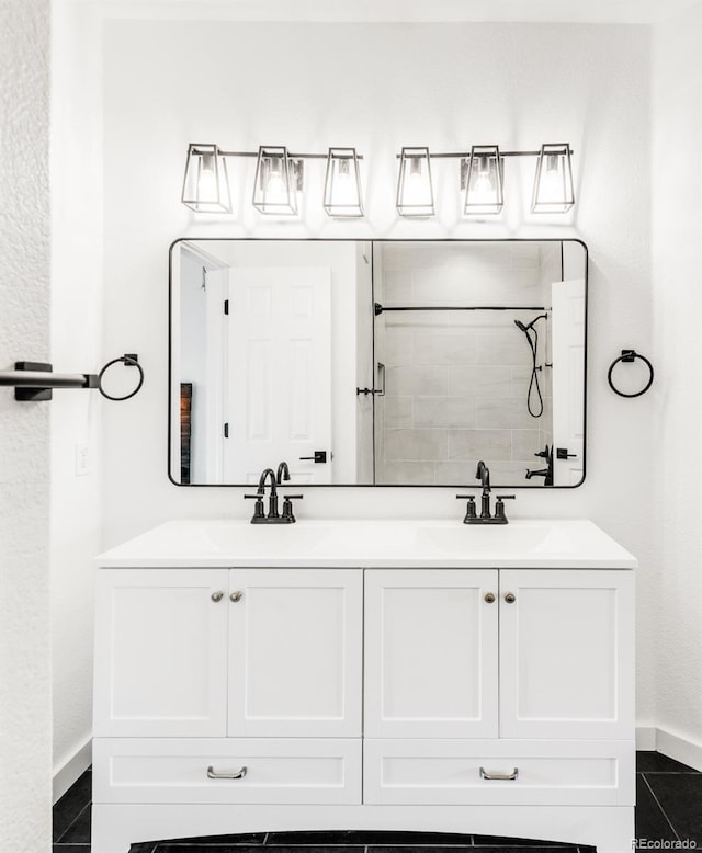 bathroom with vanity, walk in shower, and tile patterned floors