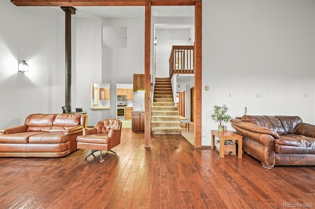 2169 Vigilante Ave, Bailey, CO 80421 - living area with wood-type flooring, stairs, and a high ceiling