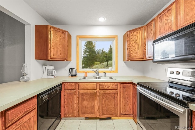 2169 Vigilante Ave, Bailey, CO 80421 - kitchen with black appliances, light countertops, light tile patterned flooring, brown cabinets, and a textured ceiling