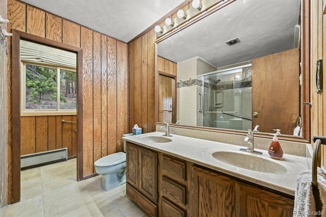 2169 Vigilante Ave, Bailey, CO 80421 - bathroom featuring a baseboard radiator, a stall shower, double vanity, wood walls, and tile patterned flooring