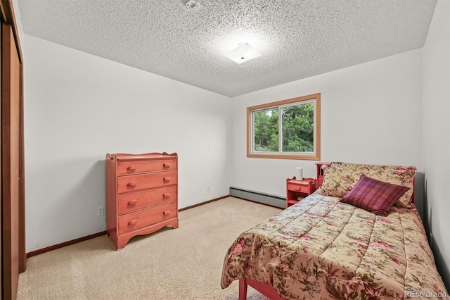 2169 Vigilante Ave, Bailey, CO 80421 - bedroom with a baseboard radiator, a textured ceiling, and light colored carpet