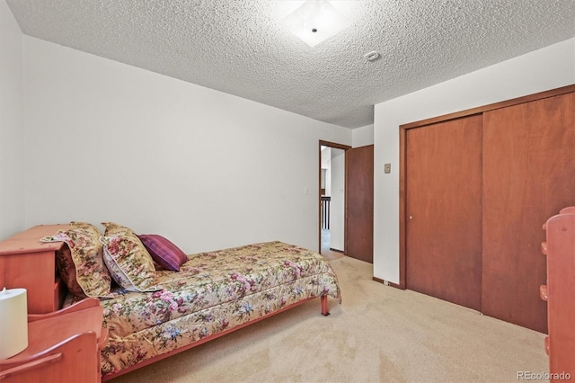 2169 Vigilante Ave, Bailey, CO 80421 - carpeted bedroom with a closet and a textured ceiling