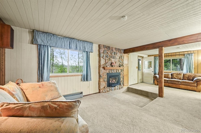 2169 Vigilante Ave, Bailey, CO 80421 - carpeted living room featuring a baseboard heating unit, wooden walls, wooden ceiling, and a fireplace