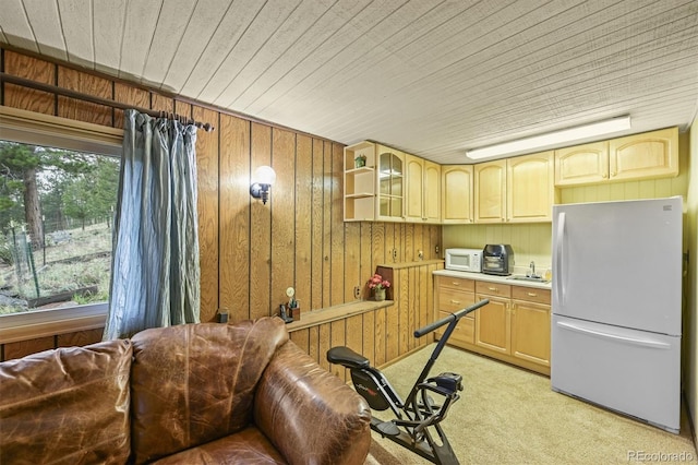 2169 Vigilante Ave, Bailey, CO 80421 - kitchen featuring white appliances, light colored carpet, wood walls, glass insert cabinets, and wooden ceiling